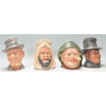 A group of four early 20th Century novelty figural character tobacco jars to include an Arabian