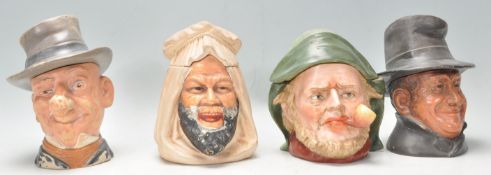 A group of four early 20th Century novelty figural character tobacco jars to include an Arabian