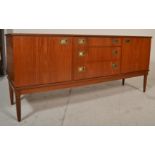 A vintage retro mid 20th Century teak wood sideboard credenza raised on a tapering supports having a