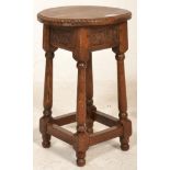 A good early 20th Century Arts and Crafts peg jointed oak stool raised on four turned supports