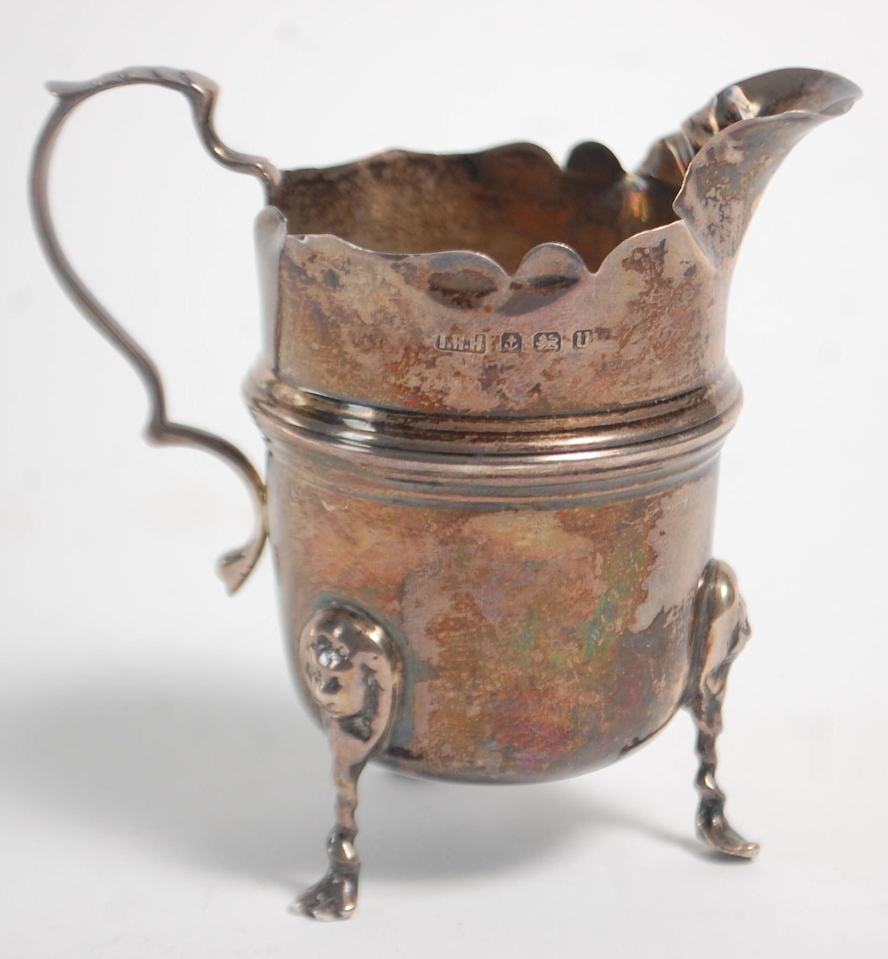 An early 20th Century silver hallmarked creamer jug having a flared top with banded center raised on - Image 4 of 9