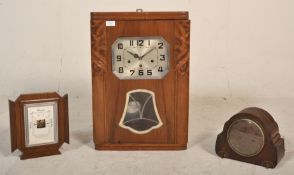 A 1930's Art Deco wooden case pendulum wall clock having a square chromed face with arabic numeral