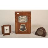 A 1930's Art Deco wooden case pendulum wall clock having a square chromed face with arabic numeral