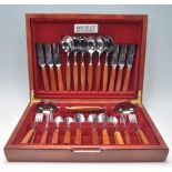 A good vintage retro 20th Century mahogany cased canteen of cutlery housing a complete set of teak
