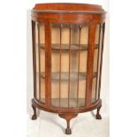 A 1930's Queen Anne walnut half moon / demi lune china display cabinet vitrine with lined shelves,