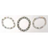 A good group of three vintage Chinese jade bead bracelets, with two similar and one having jade disc