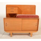 A retro mid century teak wood telephone table with velour pad seat over sliding door cupboard and