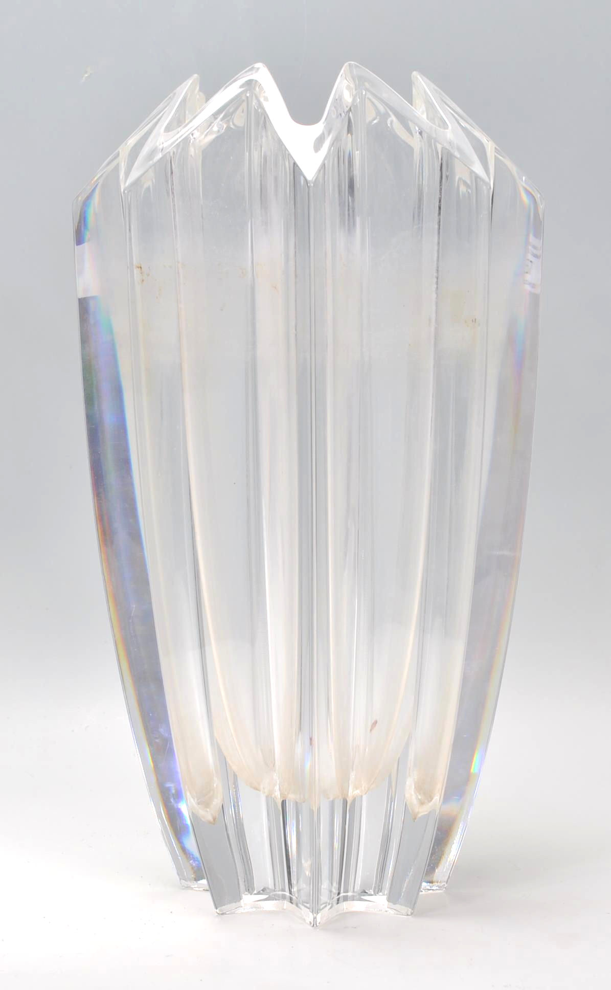 A 20th Century glass vase of faceted geometric form, having a triangular crenelated rim. Marked