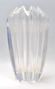 A 20th Century glass vase of faceted geometric form, having a triangular crenelated rim. Marked