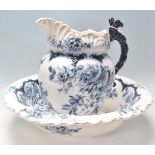 An early 20th Century Cowes china washbowl and jug having blue and white transfer printed floral