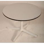 A retro mid 20th Century circular white melamine topped coffee table raised on white metal splayed