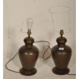 A pair of large planished brass / bronze lamps of Chinese form. The lamps / lights of baluster