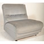 A retro 20th Century large blue button back loving chair upholstered in a light blue fabric being