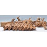 A collection of vintage wooden wood working tools to include a selection of planes including