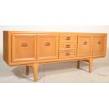 A retro mid century teak wood sideboard credenza. Raised on tapering legs with a central bank of