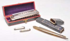 A vintage Hohner Super Chromonica harmonica in its original box together with a Joseph Rogers & Sons