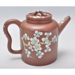 An early 20th Century Chinese brown clay teapot having hand enameled bird and floral decoration with