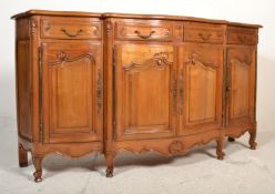 A Provincial French walnut large bow front sideboard dresser having a parquetry top with four frieze