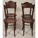 A set of four vintage 20th Century thonet style cafe dining chairs having round seats with impressed