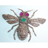 A stamped sterling silver bug brooch with moulded decoration set with ruby eyes and a round cut