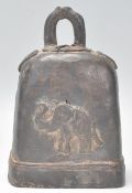 A highly unusual cow bell - herd bell of heavy form embellished with detailed elephants each side.