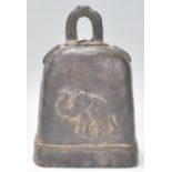 A highly unusual cow bell - herd bell of heavy form embellished with detailed elephants each side.