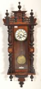 A 20th Century Vienna regulator wall clock having turned columnal supports, with a carved decoration