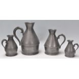 A graduating set of four 19th Century Victorian Irish pewter jugs of shapely form with scroll