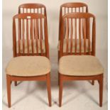 A good set of mid century Danish teak wood dining chairs being raised on turned legs united by