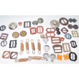 A collection of vintage belt buckles to include a selection of shapes and materials including