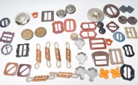 A collection of vintage belt buckles to include a selection of shapes and materials including