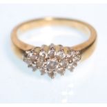 A stamped 9ct gold and diamond cluster ring having a head set with round cut diamonds. Weight 2.