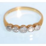 An 18ct yellow gold ladies five stone diamond ring having a five graduating diamonds of approx 0.