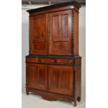 A Victorian mahogany 19th century double panelled livery cupboard / bookcase decorated with