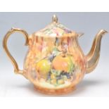 A large early to mid 20th Century teapot in the manor of Aynsley having transfer printed fruit