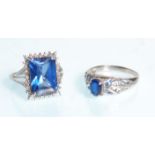 A large 9ct white gold ladies dress ring set with a large central square cut blue stone raised on