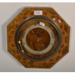 A vintage 20th Century burr walnut barometer of octagonal form having a silvered dial.  Measures