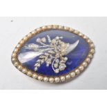 An antique gold Georgian navette brooch having a central blue enamelled panel with a floral