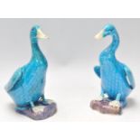 Two mid 20th Century Chinese ceramic duck figurines having a turquoise glaze, raised on naturalistic