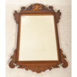 An Edwardian mahogany pier mirror having upright mirror panel in shaped mahogany frame with