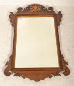 An Edwardian mahogany pier mirror having upright mirror panel in shaped mahogany frame with