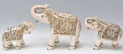A group of three vintage 20th Century bone Indian elephants having a hand painted and gilt