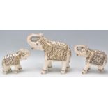 A group of three vintage 20th Century bone Indian elephants having a hand painted and gilt
