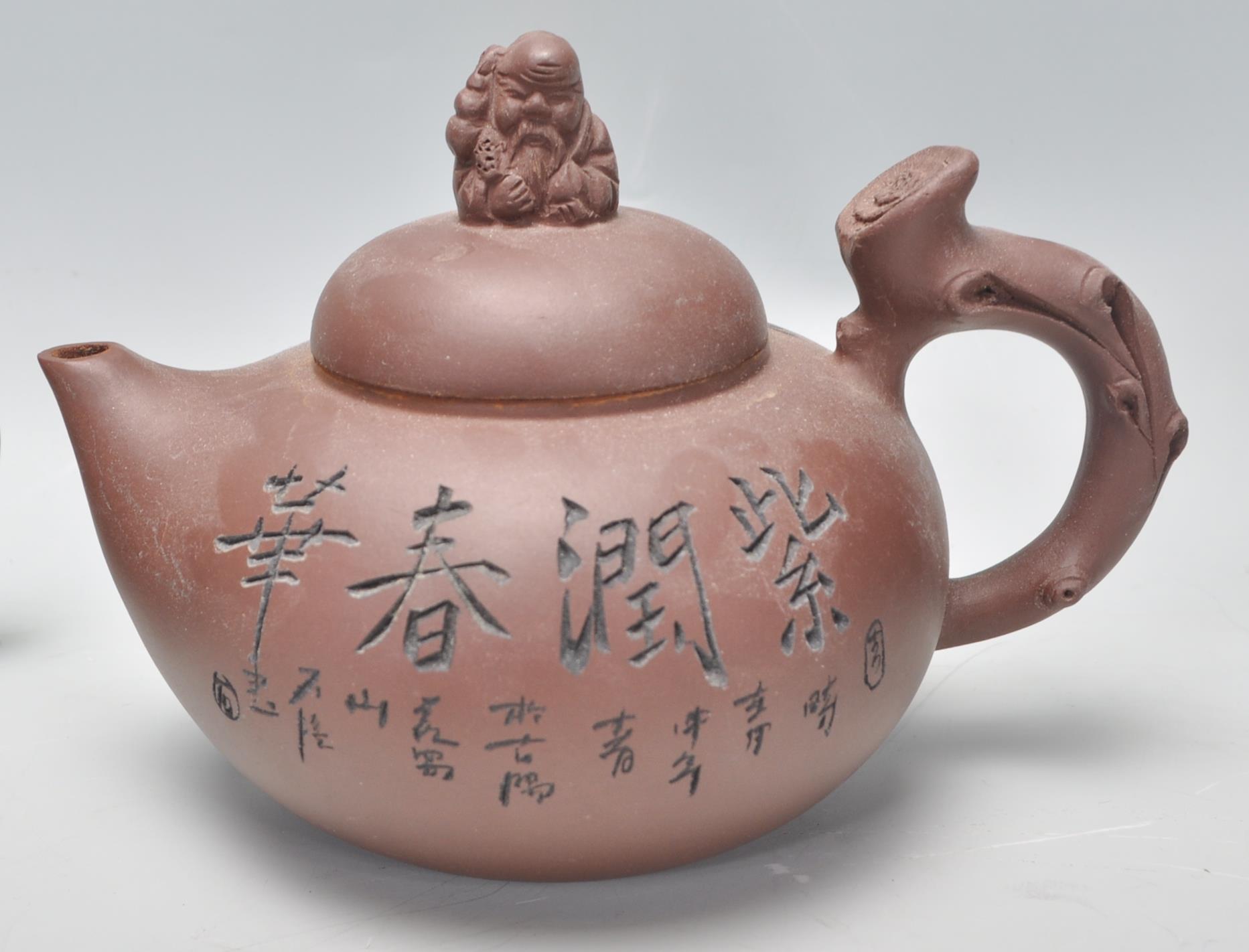 A Chinese Yixing clay teapot having carved decoration of a seated male figure with character marks - Image 4 of 13