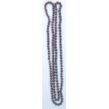 A 20th Century ladies purple cultured pearl necklace of opera length. Measures 46 inches.