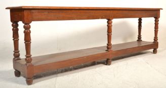 A Victorian 19th century oak drapers  table  - shop haberdashery table being raised over a plain