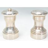 A pair of early 20th century Sterling silver condiments - salt and pepper. Each of conical form with