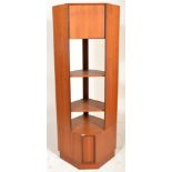 A mid century retro teak wood G-Plan corner upright bookcase cabinet being raised on a plinth base