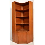 A mid century teak wood corner cabinet in the manner of G-Plan. Raised on an inset plinth base