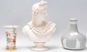 A 20th Century ceramic bisque bust depicting the Greek God Apollo together with a Wedgwood